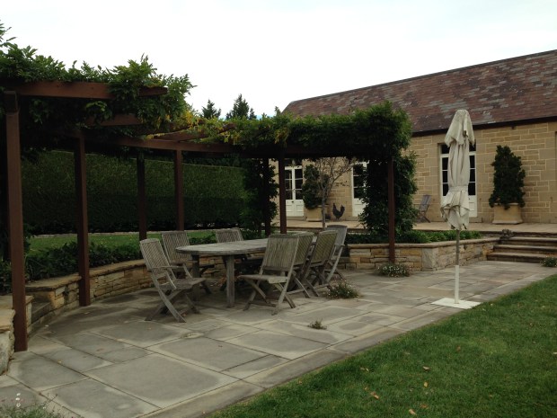 Wisteria covered pergola with outdoor dining area