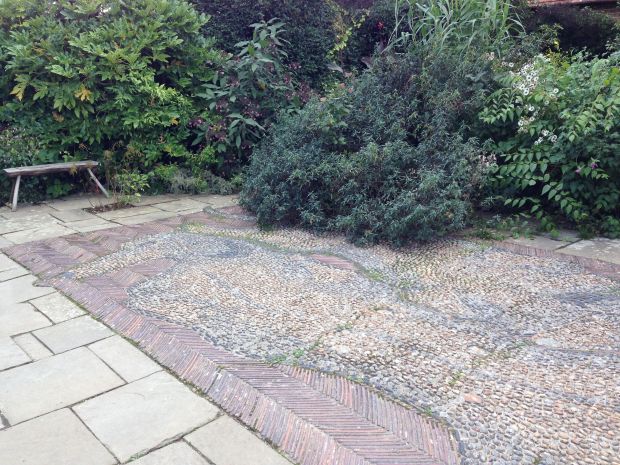 Dachshund pebble mosaic - you can just make out the face of the dog in the top left with the nose pointing to the left and the dot of the eye