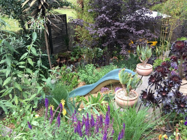 The upcycled children's slide is a novel way of getting from one area to the next (but I'm glad to say, not the only way!)