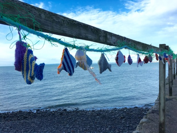 Knitted fish on the harbour wall at Clovelly