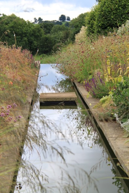 Wonderful reflections created by the still, still water at Broughton Grange, leading your eyes to the hills beyond